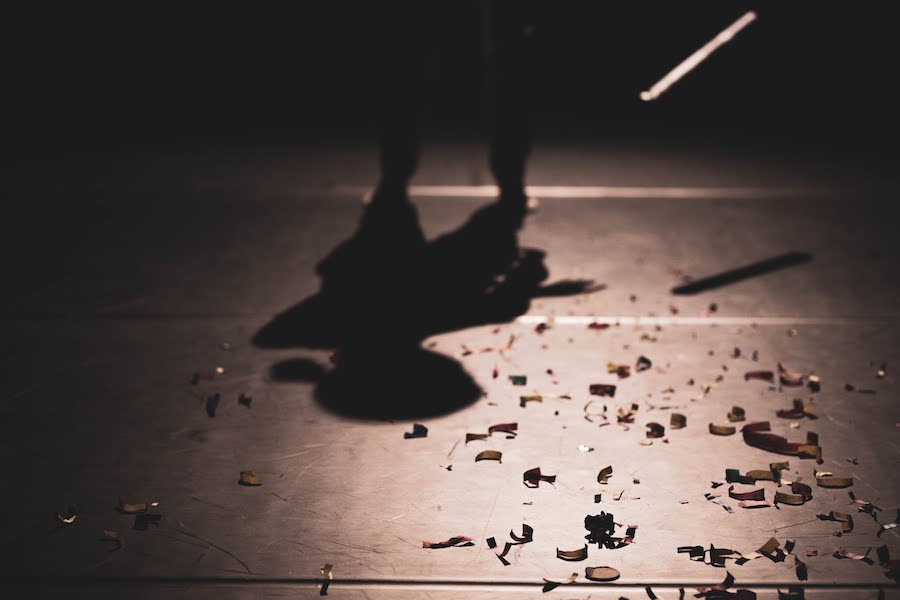 Astrid Julen's shadow on the stage floor, surrounded by confetti.